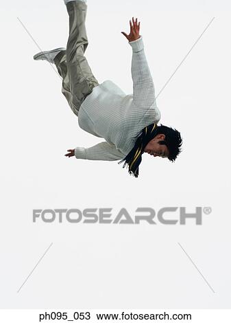 Young Asian man in pants & sweat-shirt and scarf, jumping in mid-air View Large Photo Image Stock Image - Young Asian man in pants & sweat-shirt and scarf, jumping in mid-air. Fotosearch