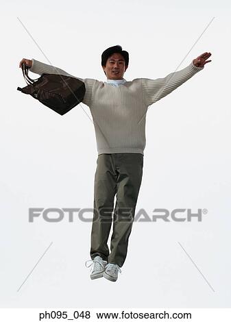 Young Asian man in pants & sweat-shirt, and tote-bag, jumping in mid-air View Large Photo Image Stock Photo - Young Asian man in pants & sweat-shirt, and tote-bag, jumping in mid-air. Fotosearch