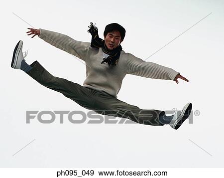 Young Asian man in pants & sweat-shirt and scarf, jumping in mid-air View Large Photo Image Stock Photo - Young Asian man in pants & sweat-shirt and scarf, jumping in mid-air. Fotosearch