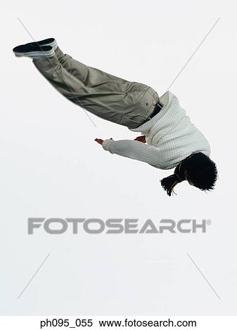 Young Asian man in pants & sweat-shirt and scarf, jumping in mid-air View Large Photo Image Stock Photography - Young Asian man in pants & sweat-shirt and scarf, jumping in mid-air. Fotosearch