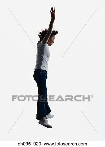 Young Asian woman in jeans & t-shirt, jumping in mid-air View Large Photo Image Stock Image - Young Asian woman in jeans & t-shirt, jumping in mid-air. Fotosearch