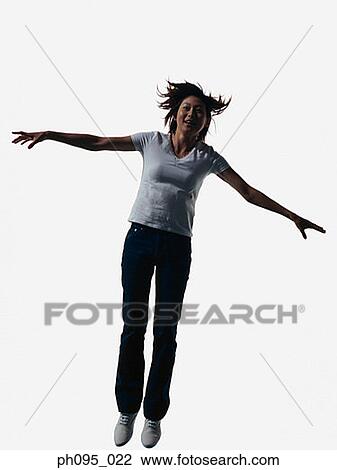 Young Asian woman in jeans & t-shirt, jumping in mid-air View Large Photo Image Stock Image - Young Asian woman in jeans & t-shirt, jumping in mid-air. Fotosearch