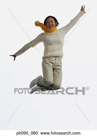 Young Asian woman in pants & sweat-shirt and scarf, jumping in mid-air View Large Photo Image Stock Image - Young Asian woman in pants & sweat-shirt and scarf, jumping in mid-air. Fotosearch