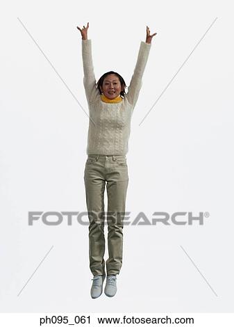 Young Asian woman in pants & sweat-shirt and scarf, jumping in mid-air View Large Photo Image Stock Image - Young Asian woman in pants & sweat-shirt and scarf, jumping in mid-air. Fotosearch