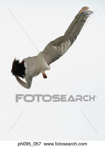 Young Asian woman in pants & sweat-shirt, jumping in mid-air View Large Photo Image Stock Photo - Young Asian woman in pants & sweat-shirt, jumping in mid-air. Fotosearch