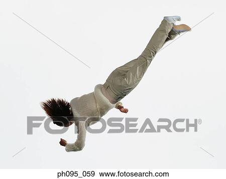 Young Asian woman in pants & sweat-shirt, jumping in mid-air View Large Photo Image Stock Photo - Young Asian woman in pants & sweat-shirt, jumping in mid-air. Fotosearch