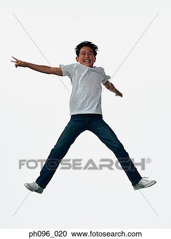 Young Asian boy in jeans & t-shirt, jumping in mid-air View Large Photo Image Stock Image - Young Asian boy in jeans & t-shirt, jumping in mid-air. Fotosearch