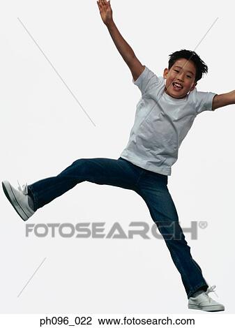 Young Asian boy in jeans & t-shirt, jumping in mid-air View Large Photo Image Stock Image - Young Asian boy in jeans & t-shirt, jumping in mid-air. Fotosearch
