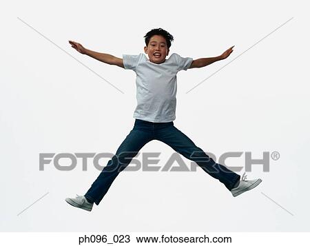 Young Asian boy in jeans & t-shirt, jumping in mid-air View Large Photo Image Stock Image - Young Asian boy in jeans & t-shirt, jumping in mid-air. Fotosearch