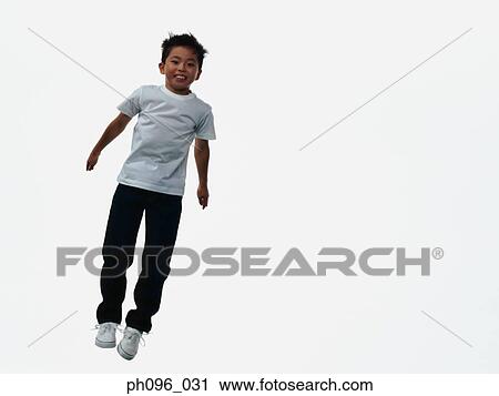 Young Asian boy in jeans & t-shirt, jumping in mid-air View Large Photo Image Stock Image - Young Asian boy in jeans & t-shirt, jumping in mid-air. Fotosearch