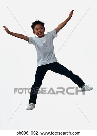Young Asian boy in jeans & t-shirt, jumping in mid-air View Large Photo Image Stock Image - Young Asian boy in jeans & t-shirt, jumping in mid-air. Fotosearch