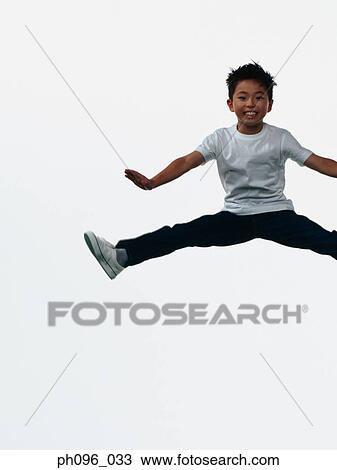 Young Asian boy in jeans & t-shirt, jumping in mid-air View Large Photo Image Stock Image - Young Asian boy in jeans & t-shirt, jumping in mid-air. Fotosearch
