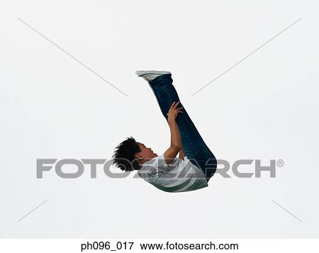 Young Asian boy in jeans & t-shirt, jumping in mid-air View Large Photo Image Stock Photo - Young Asian boy in jeans & t-shirt, jumping in mid-air. Fotosearch