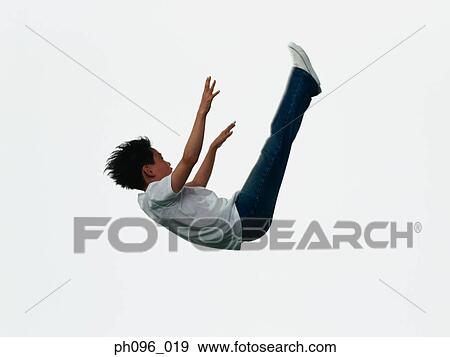 Young Asian boy in jeans & t-shirt, jumping in mid-air View Large Photo Image Stock Photo - Young Asian boy in jeans & t-shirt, jumping in mid-air. Fotosearch