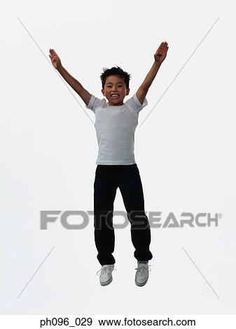 Young Asian boy in jeans & t-shirt, jumping in mid-air View Large Photo Image Stock Photo - Young Asian boy in jeans & t-shirt, jumping in mid-air. Fotosearch