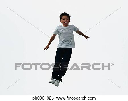 Young Asian boy in jeans & t-shirt, jumping in mid-air View Large Photo Image Stock Photography - Young Asian boy in jeans & t-shirt, jumping in mid-air. Fotosearch