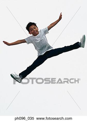 Young Asian boy in jeans & t-shirt, jumping in mid-air View Large Photo Image Stock Photography - Young Asian boy in jeans & t-shirt, jumping in mid-air. Fotosearch