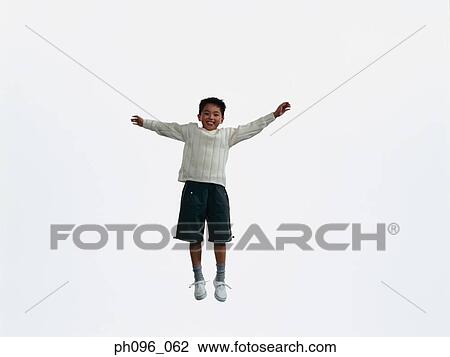 Young Asian boy in shorts & sweat-shirt, jumping in mid-air View Large Photo Image Stock Image - Young Asian boy in shorts & sweat-shirt, jumping in mid-air. Fotosearch