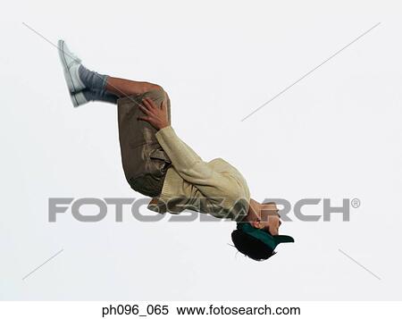 Stock Photography - Young Asian boy in shorts & sweat-shirt, jumping in mid-air. Fotosearch
