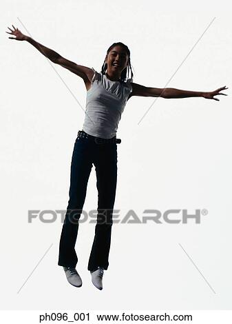Young Asian girl in jeans & t-shirt, jumping in mid-air View Large Photo Image Stock Image - Young Asian girl in jeans & t-shirt, jumping in mid-air. Fotosearch