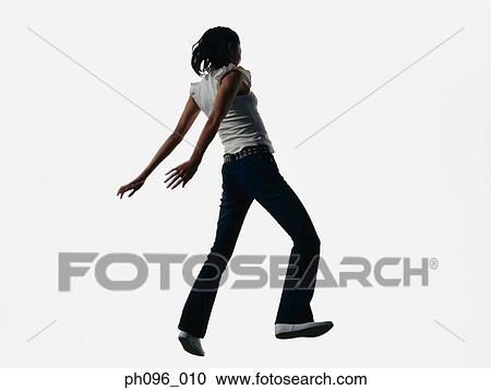 Young Asian girl in jeans & t-shirt, jumping in mid-air View Large Photo Image Stock Image - Young Asian girl in jeans & t-shirt, jumping in mid-air. Fotosearch