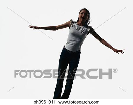 Young Asian girl in jeans & t-shirt, jumping in mid-air View Large Photo Image Stock Image - Young Asian girl in jeans & t-shirt, jumping in mid-air. Fotosearch