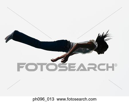 Young Asian girl in jeans & t-shirt, jumping in mid-air View Large Photo Image Stock Image - Young Asian girl in jeans & t-shirt, jumping in mid-air. Fotosearch