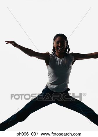 Young Asian girl in jeans & t-shirt, jumping in mid-air View Large Photo Image Stock Photo - Young Asian girl in jeans & t-shirt, jumping in mid-air. Fotosearch