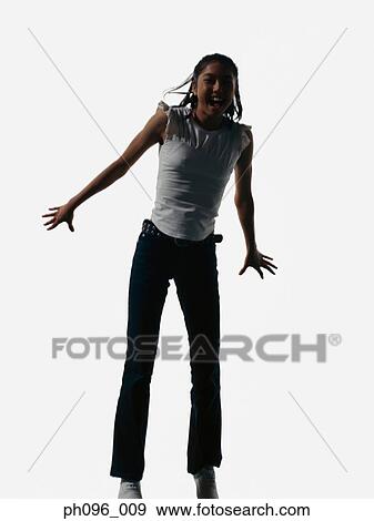 Young Asian girl in jeans & t-shirt, jumping in mid-air View Large Photo Image Stock Photo - Young Asian girl in jeans & t-shirt, jumping in mid-air. Fotosearch