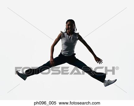 Stock Photography - Young Asian girl in jeans & t-shirt, jumping in mid-air. Fotosearch
