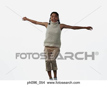 Young Asian girl in shorts & cardigan, jumping in mid-air View Large Photo Image Picture - Young Asian girl in shorts & cardigan, jumping in mid-air. Fotosearch