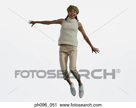 Young Asian girl in shorts & cardigan, jumping in mid-air View Large Photo Image Stock Image - Young Asian girl in shorts & cardigan, jumping in mid-air. Fotosearch