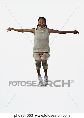 Young Asian girl in shorts & cardigan, jumping in mid-air View Large Photo Image Stock Image - Young Asian girl in shorts & cardigan, jumping in mid-air. Fotosearch