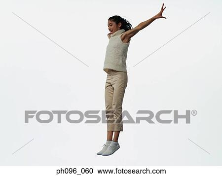 Young Asian girl in shorts & cardigan, jumping in mid-air View Large Photo Image Stock Image - Young Asian girl in shorts & cardigan, jumping in mid-air. Fotosearch