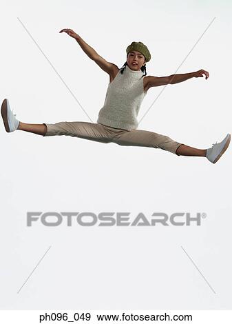 Young Asian girl in shorts & cardigan, jumping in mid-air View Large Photo Image Stock Photo - Young Asian girl in shorts & cardigan, jumping in mid-air. Fotosearch
