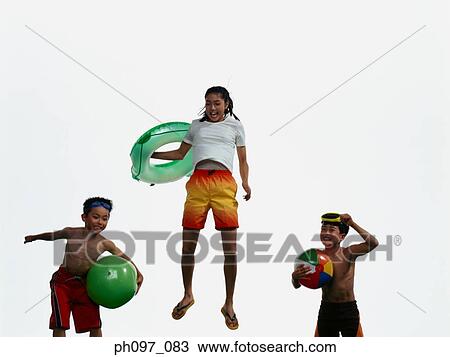 Group of friends in beach wear, jumping in mid-air View Large Photo Image Stock Image - Group of friends in beach wear, jumping in mid-air. Fotosearch