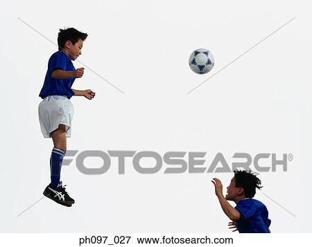 Two young Asian boys playing football in mid-air View Large Photo Image Stock Photo - Two young Asian boys playing football in mid-air. Fotosearch