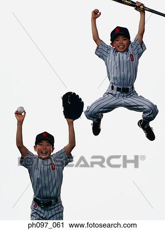 Two young baseball players jumping in mid-air View Large Photo Image Stock Image - Two young baseball players jumping in mid-air. Fotosearch
