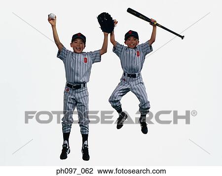 Stock Image - Two young baseball players jumping in mid-air. Fotosearch