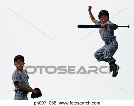 Stock Photo - Two young baseball players jumping in mid-air. Fotosearch