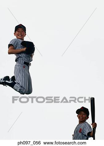 Stock Photograph - Two young baseball players jumping in mid-air. Fotosearch