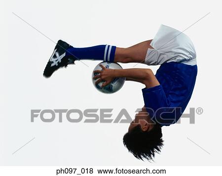 Young Asian boy holding football, jumping in mid-air View Large Photo Image Stock Photo - Young Asian boy holding football, jumping in mid-air. Fotosearch
