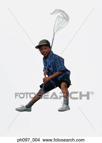 Young Asian boy with butterfly net, jumping in mid-air View Large Photo Image Picture - Young Asian boy with butterfly net, jumping in mid-air. Fotosearch