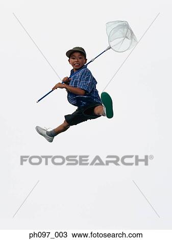 Young Asian boy with butterfly net, jumping in mid-air View Large Photo Image Stock Image - Young Asian boy with butterfly net, jumping in mid-air. Fotosearch