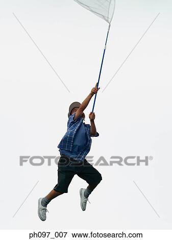 Young Asian boy with butterfly net, jumping in mid-air View Large Photo Image Stock Photo - Young Asian boy with butterfly net, jumping in mid-air. Fotosearch