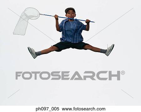Young Asian boy with butterfly net, jumping in mid-air View Large Photo Image Stock Photography - Young Asian boy with butterfly net, jumping in mid-air. Fotosearch