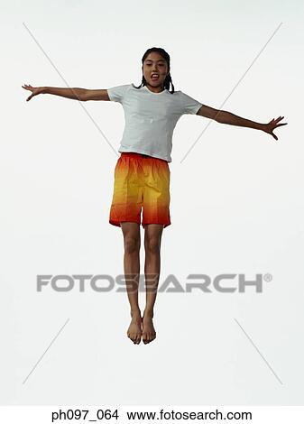 Young Asian girl in shorts & t-shirt, jumping in mid-air View Large Photo Image Picture - Young Asian girl in shorts & t-shirt, jumping in mid-air. Fotosearch