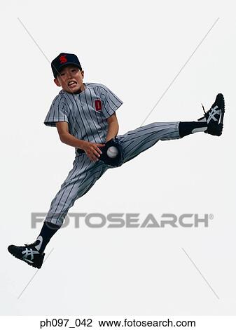 Young Baseball player catching ball in glove in mid-air View Large Photo Image Stock Image - Young Baseball player catching ball in glove in mid-air. Fotosearch
