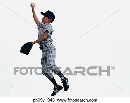 Stock Image - Young Baseball player catching ball in glove in mid-air. Fotosearch