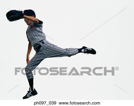 Stock Photo - Young Baseball player catching ball in glove in mid-air. Fotosearch